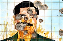A tile mosaic of Saddam Hussein riddled with bullets