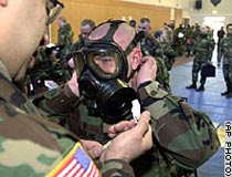 A U.S. soldier trying on a gas mask