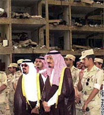 Saudi officials survey an apartment complex destroyed by a terrorist bombing in Riyadh, Saudi Arabia
