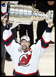 New Jersey Devils captain Scott Stevens holds up the Stanley Cup after the team's victory