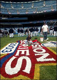 Workers put finishing touches on the baseball field before the 2003 Division Series playoffs