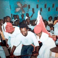 Vodou practioners using drapo during their ceremony