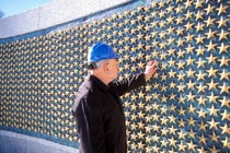 Man looking at the gold stars at the World War II Memorial