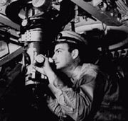Navy commander looking through the submarine's periscope