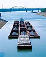 Barges are used to transport raw materials, like coal.