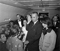 Vice President Lyndon B. Johnson swearing in as President aboard Air Force One following the assasination of President John F. Kennedy.