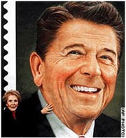 Nancy Reagan touches a large version of the commemorative postage stamp bearing the portrait of her late husband, President Ronald Reagan.
