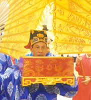 Reverent officials place a petition to the local god Ly Phuc Man in an ornate box, as part of the Gia Festival.